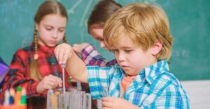 boy and 2 girls doing science experiment
