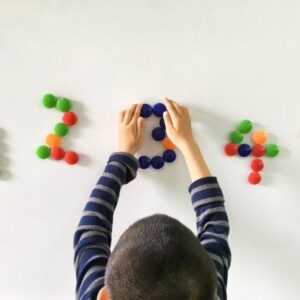 img of a child counting with colorful dots