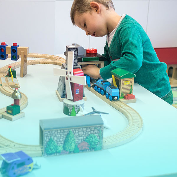 boy playing with train