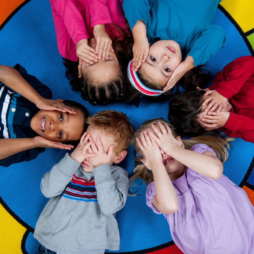 Kids covering their eyes and ears on a colorful wheel